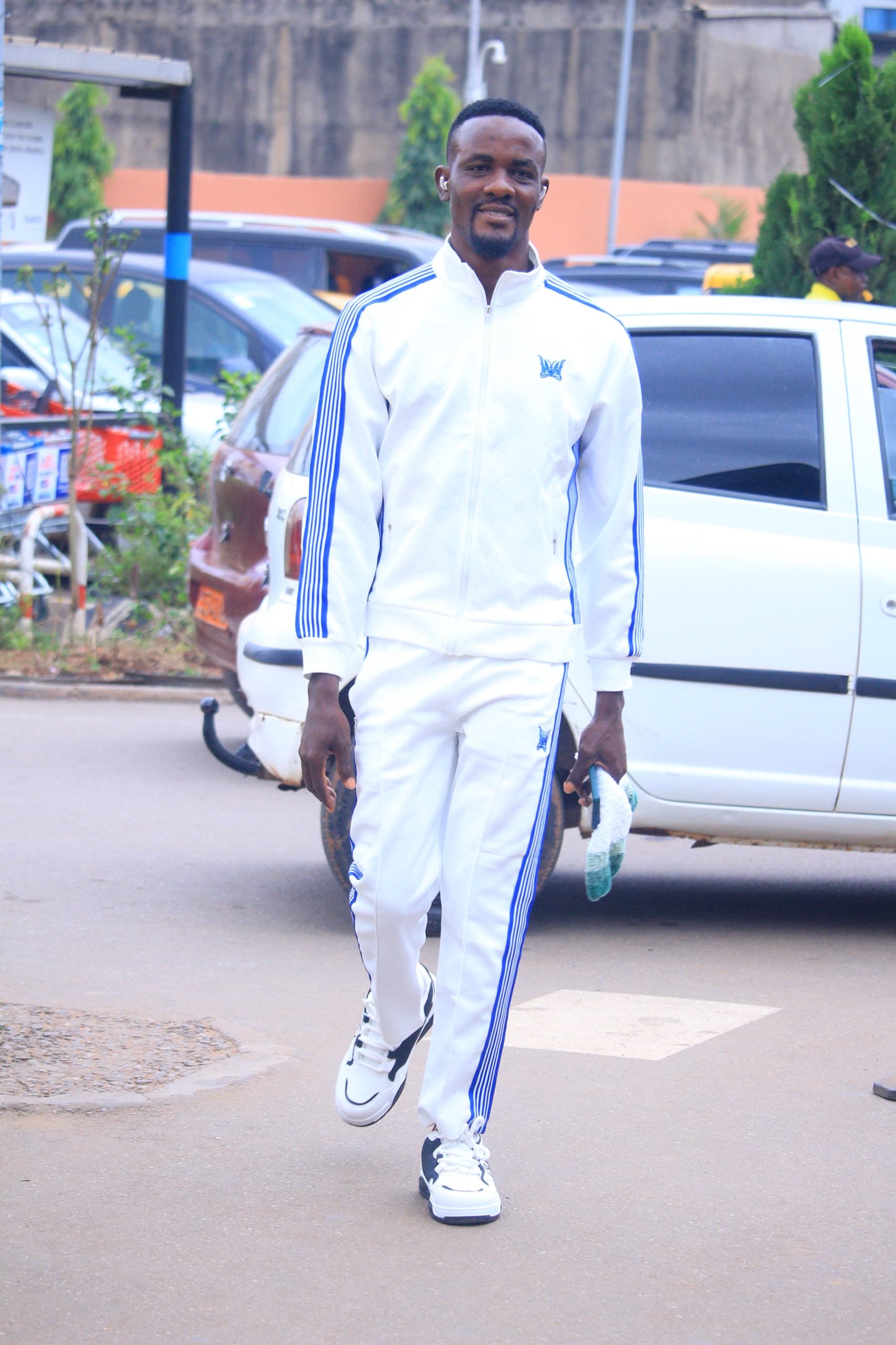 Prophet Emmanuel Ayuh walking on a street in Yaoundé.